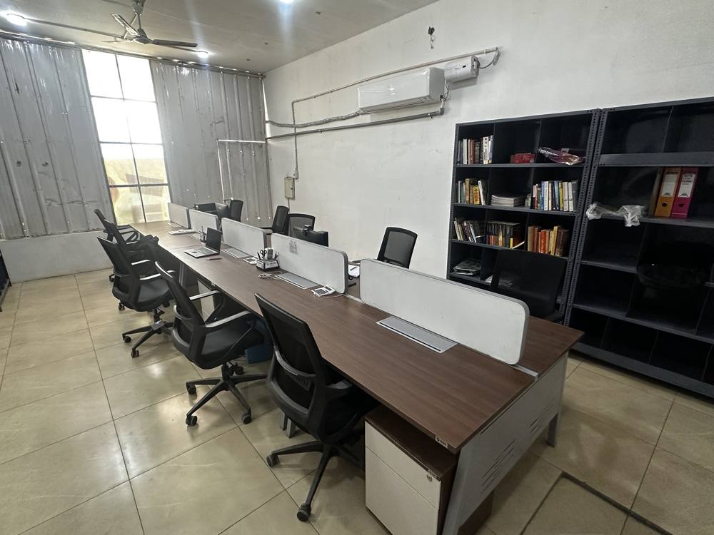 Row of desks with bookshelves and an air conditioner